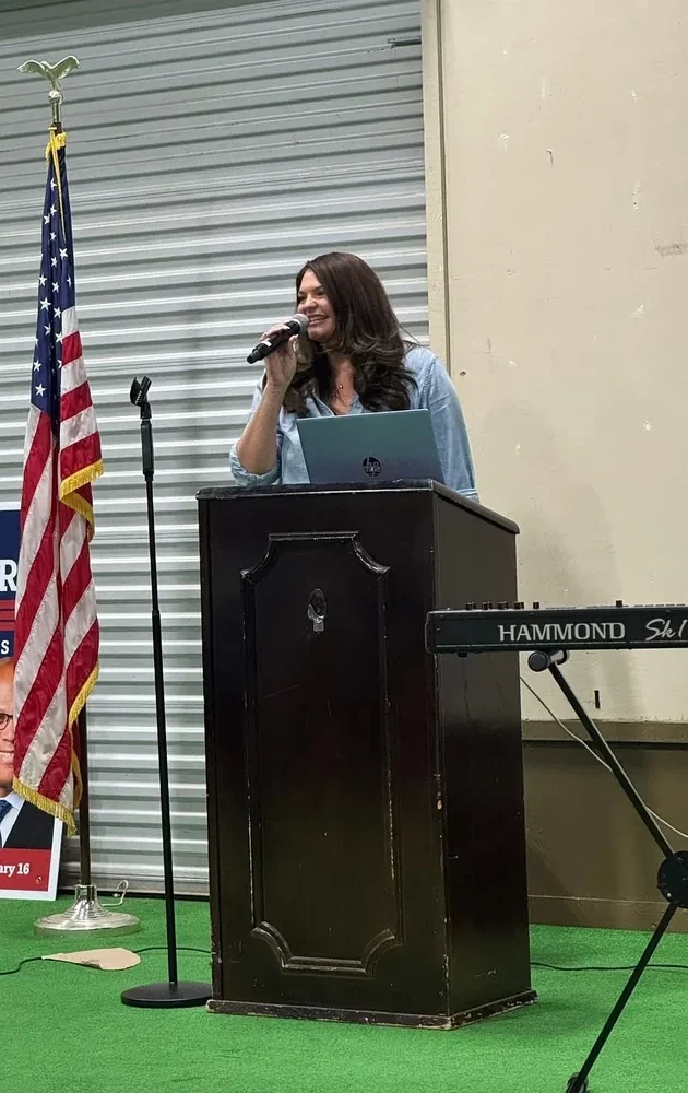 Whitney delivering a speech at a community event